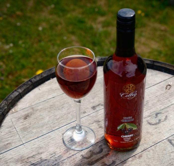 Celtic Country Wine with glass on barrel