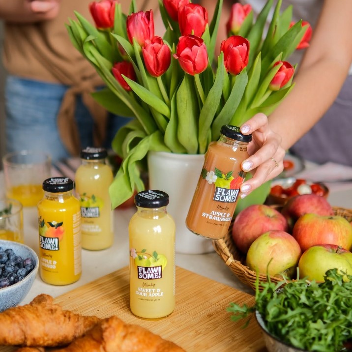 Flawsome juices on table with tulips
